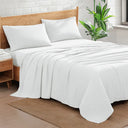 White cotton sheet set on wooden bed with pillows, soft breathable bedding for comfortable sleep