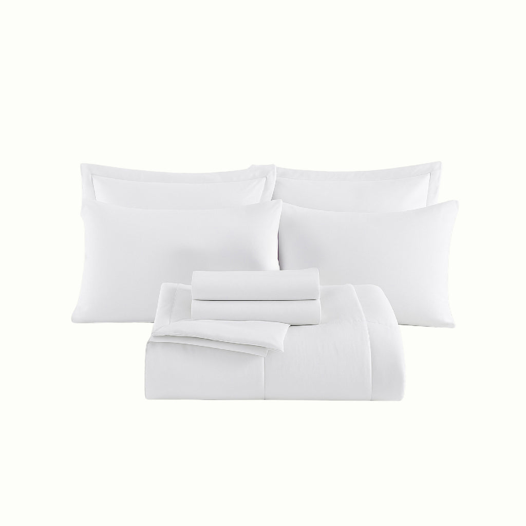 Complete cozy bedding ensemble with plush comforter and soft sheets displayed on a modern bedroom bed.