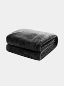 Beddora flannel throw blanket with soft, warm fabric laid out to show cozy texture ideal for couches, beds, or reading chairs.