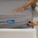 Soft, breathable mattress protector fitted on bed with pillows and sheets for bedroom styling.
