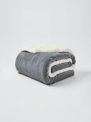 Beddora all-season sherpa throw blanket draped over a couch for living room decor and warmth.