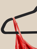 Close‑up of a velvet hanger showing soft textured surface and sturdy chrome swivel hook for easy wardrobe organization. 